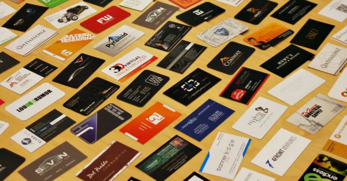 Collection of business card designs arranged on a wooden table