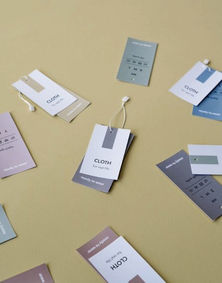 Printed hang tags and custom labels arranged on a table