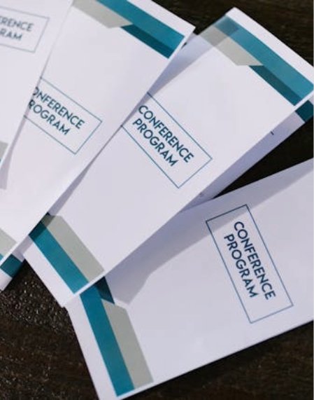 Folded printed conference program brochures on a table